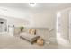 Well-lit hallway with carpet, bench, and decorative plants, offering a bright and welcoming transition space at 1037 Panoramic Pte, Buford, GA 30518