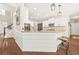 Bright kitchen with white cabinets, granite countertops, stainless steel appliances, and stylish pendant lighting at 1037 Panoramic Pte, Buford, GA 30518