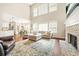 Bright open living room showcasing vaulted ceilings, fireplace, and an open concept to the kitchen at 1037 Panoramic Pte, Buford, GA 30518