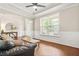 Elegant living room with hardwood floors, wainscoting, and a large window for a bright, inviting atmosphere at 1037 Panoramic Pte, Buford, GA 30518