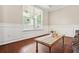 Bright living room with hardwood floors, wainscoting, and a large window for natural light and charm at 1037 Panoramic Pte, Buford, GA 30518