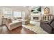 Cozy living room featuring a fireplace, large sectional, with plenty of natural light from the windows at 1037 Panoramic Pte, Buford, GA 30518