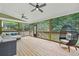 Relaxing screened porch with comfortable seating, ceiling fans, and views of the private backyard at 1037 Panoramic Pte, Buford, GA 30518