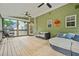 Relaxing screened porch offers ample seating with stylish sofas and hanging chair, blending comfort with nature at 1037 Panoramic Pte, Buford, GA 30518