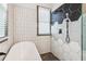Contemporary bathroom featuring modern tiling, walk-in shower, and a freestanding tub at 1393 Westview Sw Dr, Atlanta, GA 30310