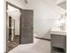 Bathroom displays a grey vanity with brushed gold fixtures, hexagon tile flooring, and a toilet at 1393 Westview Sw Dr, Atlanta, GA 30310
