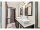 Bathroom featuring double sinks, dark cabinets, and sliding barn door access at 1393 Westview Sw Dr, Atlanta, GA 30310