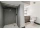 Bathroom boasts a walk-in shower with grey tiling, a grey vanity, toilet and hexagon tile flooring at 1393 Westview Sw Dr, Atlanta, GA 30310