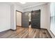 Bedroom featuring a sliding barn door, hardwood-style floors, and neutral walls at 1393 Westview Sw Dr, Atlanta, GA 30310