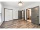 Bedroom with wood-look floors, three doorways, and an overhead light fixture at 1393 Westview Sw Dr, Atlanta, GA 30310
