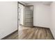 Bedroom features modern gray door, wood-look flooring, and fresh white walls at 1393 Westview Sw Dr, Atlanta, GA 30310