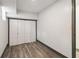 Bedroom featuring wood flooring, white walls, neutral trim, and a double-door closet at 1393 Westview Sw Dr, Atlanta, GA 30310