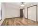 Bedroom featuring wood flooring, white walls, neutral trim, closet with double doors, and a window at 1393 Westview Sw Dr, Atlanta, GA 30310