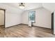 Bedroom with wood flooring, white walls, neutral trim, and a window with wooded scenery at 1393 Westview Sw Dr, Atlanta, GA 30310