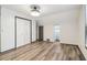 Bedroom featuring wood flooring, white walls, neutral trim, closet with double doors, and a window at 1393 Westview Sw Dr, Atlanta, GA 30310