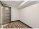 Bedroom features modern gray door, wood-look flooring, and fresh white walls at 1393 Westview Sw Dr, Atlanta, GA 30310