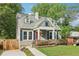 Charming home with a red door, dormer windows and a well-manicured lawn with a wooden fence at 1393 Westview Sw Dr, Atlanta, GA 30310