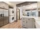 Modern kitchen featuring a stainless steel refrigerator, stacked washer/dryer, and an open layout at 1393 Westview Sw Dr, Atlanta, GA 30310