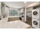 Well-equipped kitchen with stainless steel appliances, quartz counters, and a convenient stacked washer/dryer unit at 1393 Westview Sw Dr, Atlanta, GA 30310