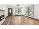 Bright open-concept living room with stone fireplace and hardwood floors at 1393 Westview Sw Dr, Atlanta, GA 30310