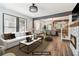 Bright open-concept living room with stone fireplace, hardwood floors, and a seamless flow to the dining area at 1393 Westview Sw Dr, Atlanta, GA 30310