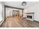 Bright open-concept living room with stone fireplace and hardwood floors at 1393 Westview Sw Dr, Atlanta, GA 30310