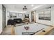 Open-concept living room with pool table, contemporary decor and plenty of space at 1393 Westview Sw Dr, Atlanta, GA 30310