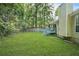 View of the spacious backyard with a small deck and a wood fence surrounded by mature trees at 2107 Sandtree Sw Ct, Atlanta, GA 30331