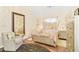 Charming bedroom featuring decorative lighting, an accent chair, and a large mirror at 2107 Sandtree Sw Ct, Atlanta, GA 30331