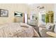 This bright bedroom features a vaulted ceiling, TV, and views into the bathroom at 2107 Sandtree Sw Ct, Atlanta, GA 30331