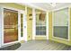 Charming front porch featuring a decorative floral piece and a secure entry door at 2107 Sandtree Sw Ct, Atlanta, GA 30331