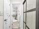 This hallway offers views to a full bathroom with a tub and a glass door at 2107 Sandtree Sw Ct, Atlanta, GA 30331