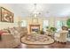Spacious living room with a fireplace, chandelier, and decor at 2107 Sandtree Sw Ct, Atlanta, GA 30331