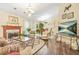 Spacious living room with decorative fireplace, chandelier, and hardwood floors at 2107 Sandtree Sw Ct, Atlanta, GA 30331