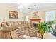 Bright living room featuring a fireplace and decorative chandelier at 2107 Sandtree Sw Ct, Atlanta, GA 30331