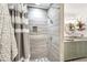 Bright, modern shower with gray tile, a shower niche, and stylish fixtures at 2107 Sandtree Sw Ct, Atlanta, GA 30331