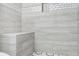 This modern shower features gray textured tiles and a built-in shower seat at 2107 Sandtree Sw Ct, Atlanta, GA 30331