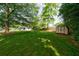 Large, lush backyard with a storage shed nestled among mature trees, offering a serene and private outdoor space at 3060 Wilson Rd, Decatur, GA 30033