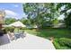 Spacious backyard featuring a large deck with an umbrella table and chairs, surrounded by lush greenery at 3060 Wilson Rd, Decatur, GA 30033