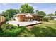Backyard featuring a dining set on a white deck with lush landscaping and lawn at 3060 Wilson Rd, Decatur, GA 30033