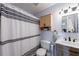 Bathroom features a black and white striped shower curtain, and vanity with storage at 3060 Wilson Rd, Decatur, GA 30033