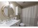Cozy bathroom with marble countertop, decorative mirror, and striped shower curtain at 3060 Wilson Rd, Decatur, GA 30033