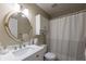 Cozy bathroom with white vanity, oval mirror, and shower with updated hardware and decor at 3060 Wilson Rd, Decatur, GA 30033