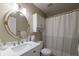 Cozy bathroom with a white vanity, framed mirror, and shower-tub combo at 3060 Wilson Rd, Decatur, GA 30033