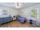 Comfortable bedroom featuring hardwood floors, a ceiling fan, and natural light at 3060 Wilson Rd, Decatur, GA 30033