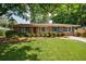 Charming single-story brick home featuring blue shutters and a well-manicured lawn and mature trees at 3060 Wilson Rd, Decatur, GA 30033