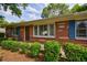 Close up of a charming brick home featuring a well-manicured lawn and front entrance at 3060 Wilson Rd, Decatur, GA 30033