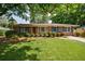 Charming brick home with a well-manicured lawn, mature trees, and a classic design at 3060 Wilson Rd, Decatur, GA 30033