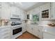 Bright kitchen featuring white cabinets, subway tile backsplash, and modern appliances at 3060 Wilson Rd, Decatur, GA 30033