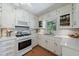 Bright kitchen with white cabinetry, modern appliances, and tile backsplash at 3060 Wilson Rd, Decatur, GA 30033
